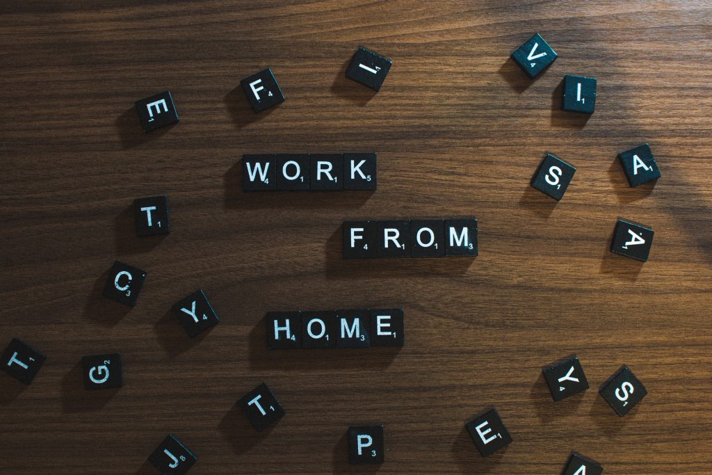 Photo by Nelly Antoniadou - image of small scrabble like letters in black wooden pieces, saying Work from home